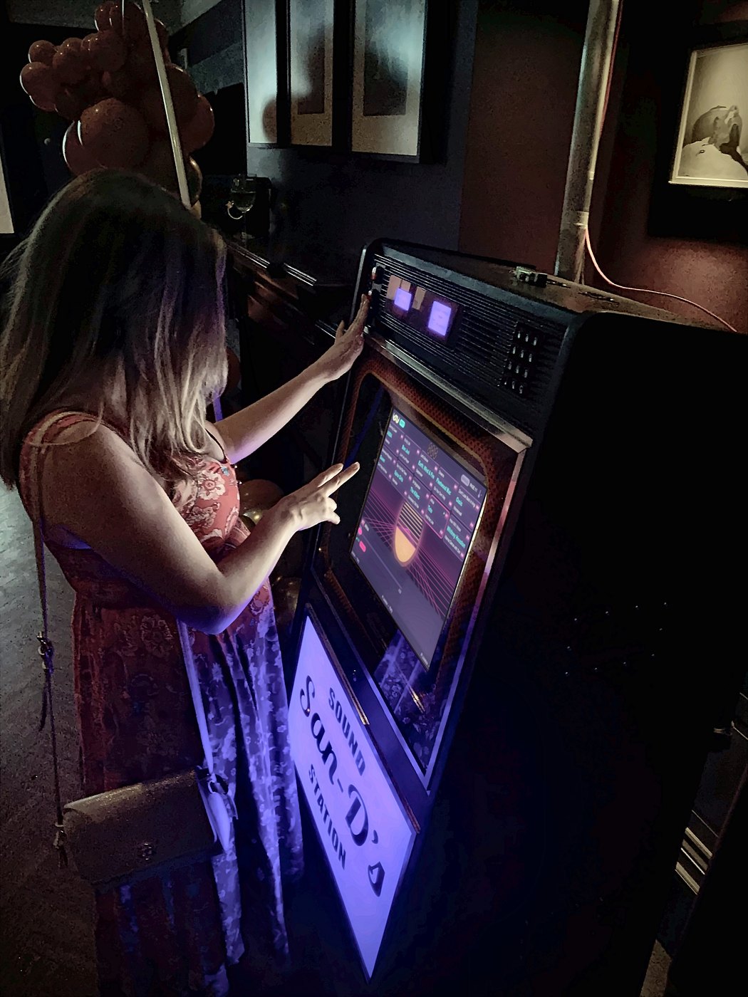 Guest choosing a song on the Sir Juke hire jukebox at a party