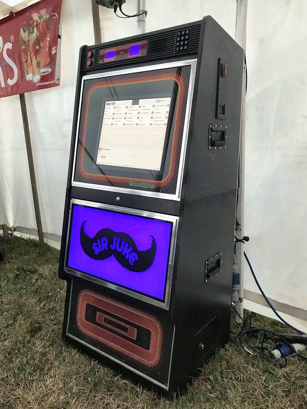 Jukebox hire set up in the beer tent at a festival, with the Sir Juke light box glowing blue